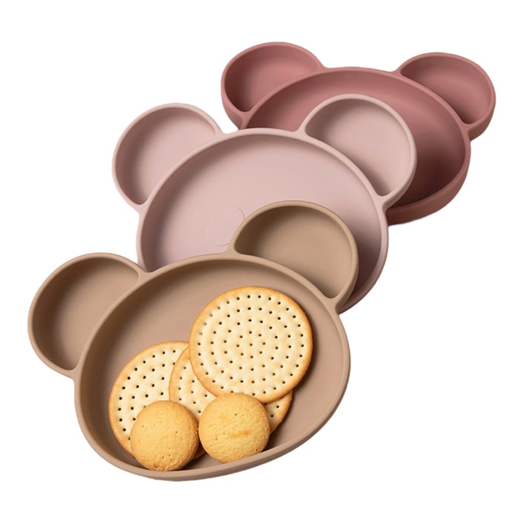Suction silicone baby plate filled with food, designed for easy and clean feeding.